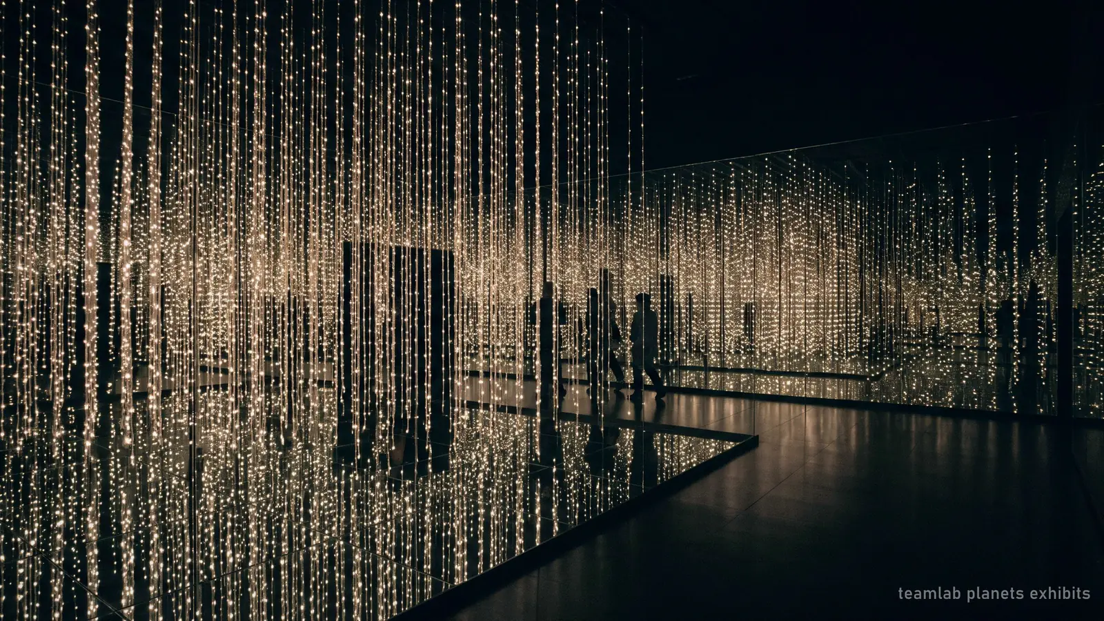 Illustration: a dark room of hanging points of light reflected in mirrors, evoking the light installations inside teamLab Planets